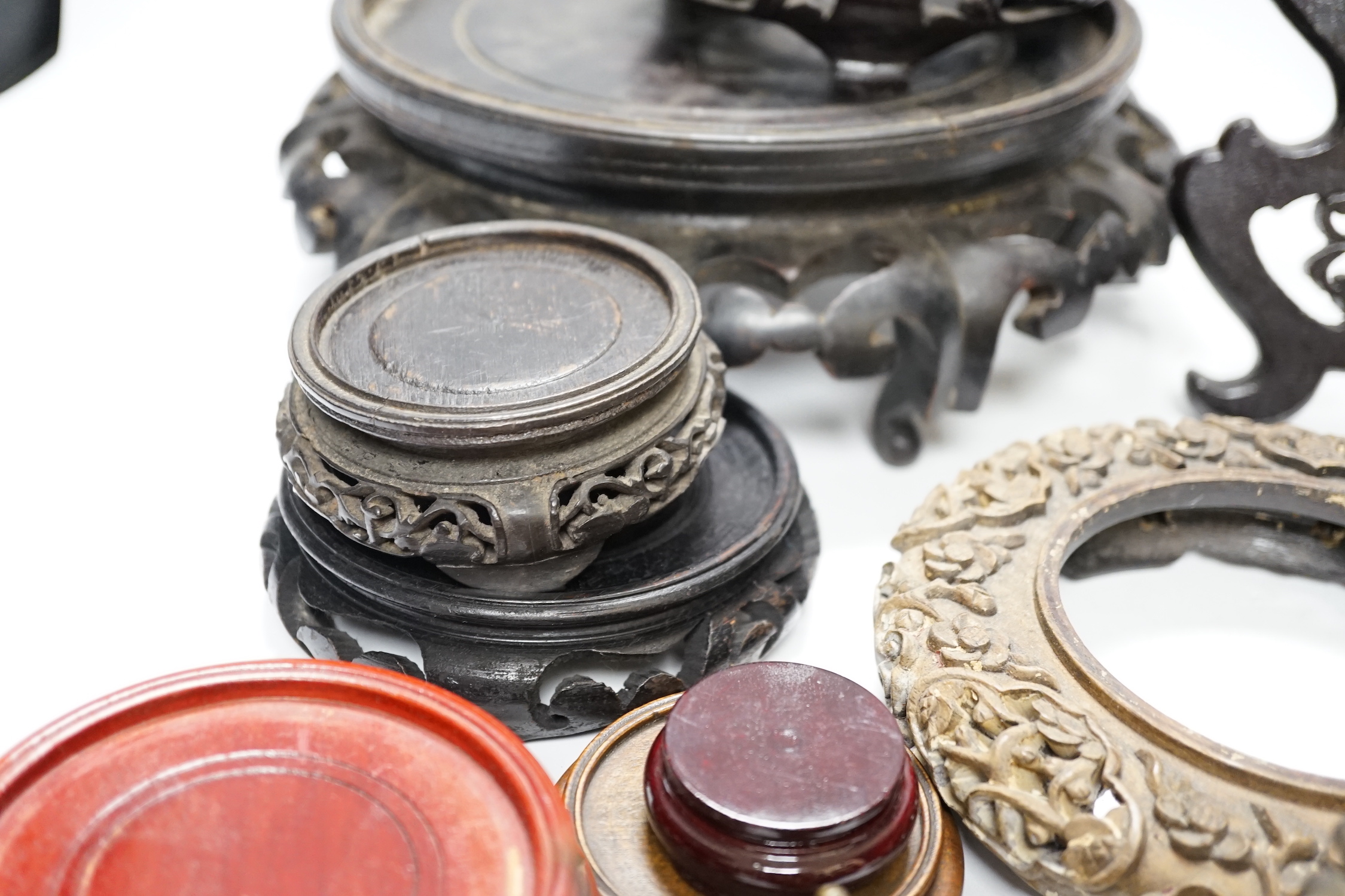 Assorted Chinese wooden and metal stands, largest 25cm in diameter